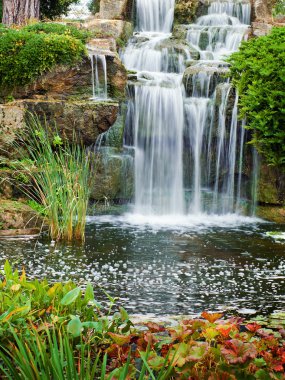Waterfall in city park clipart