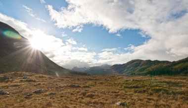 Rising Sun on a Glen next to Fort William, Scotland clipart