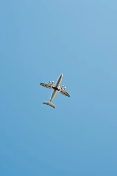 stock image Plane flying through blue sky