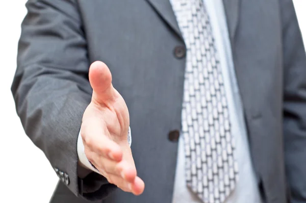 Businessman in dark suit extending hand to shake — Stock Photo, Image