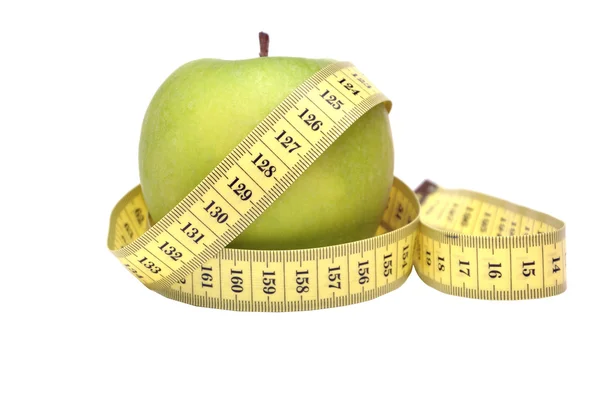 Zelené jablko a Svinovací metr — Stock fotografie