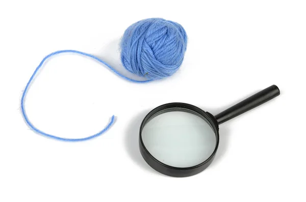 Magnifier and wool ball — Stock Photo, Image