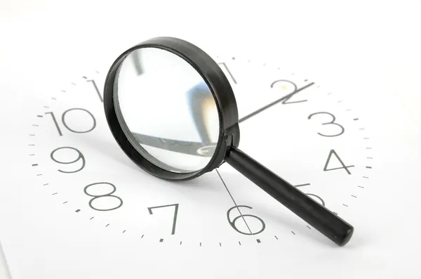 Clock face and magnifier — Stock Photo, Image