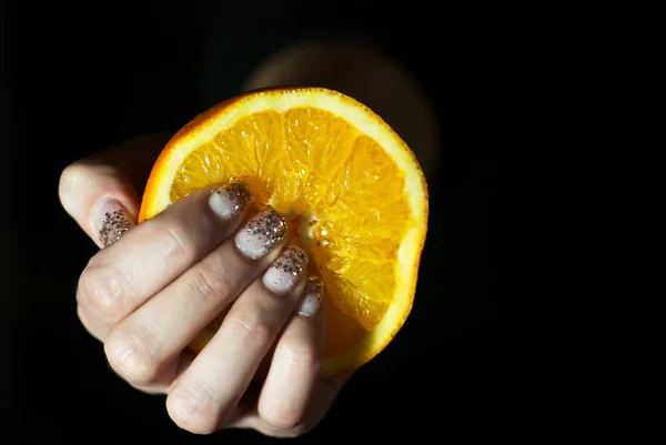Orange in woman´s hand — ストック写真