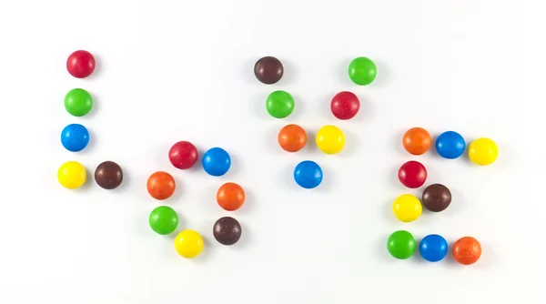 Titul láska barevné cukroví — Stock fotografie