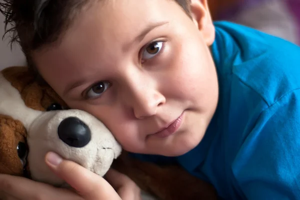 Little boy with his puppy toy — Stock Photo, Image
