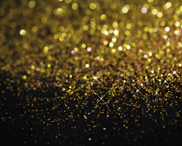 Gold glitter on black background