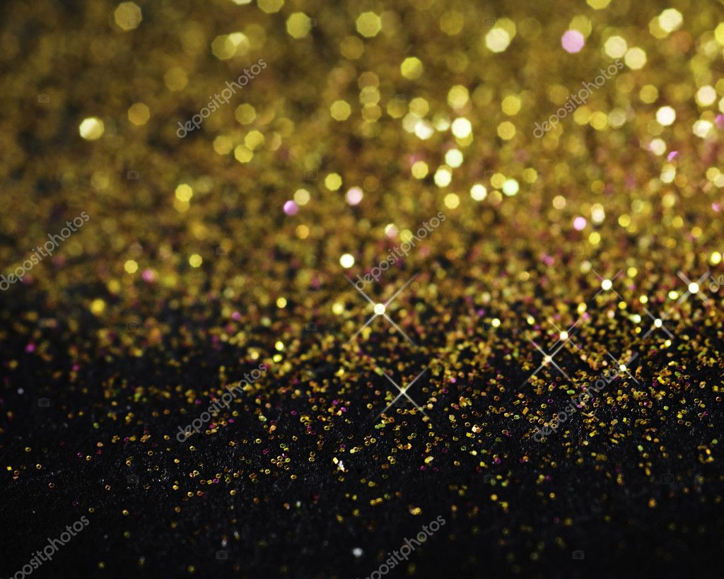Gold glitter on black background Stock Photo by ©karidesign 10555485