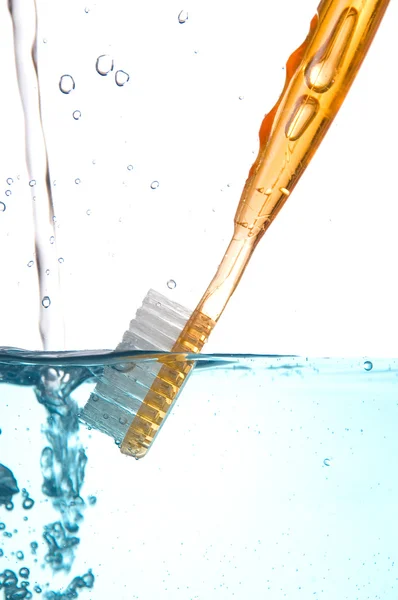 stock image Rinsing a toothbrush in water