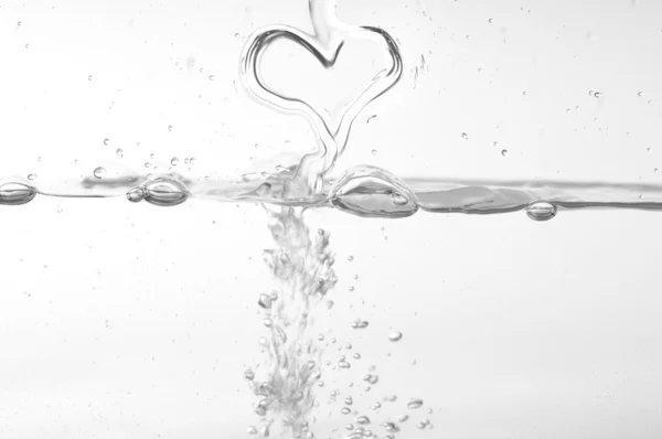 Pouring a heart into the water — Stock Photo, Image