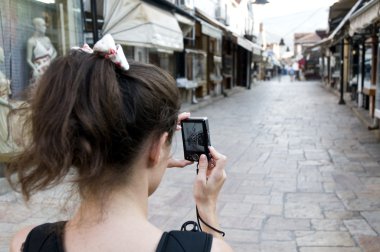 The girl who takes a photo of the downtown clipart