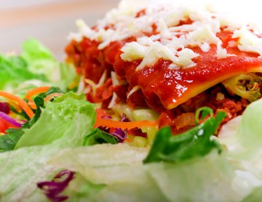 Close up of Lasagana with salad clipart