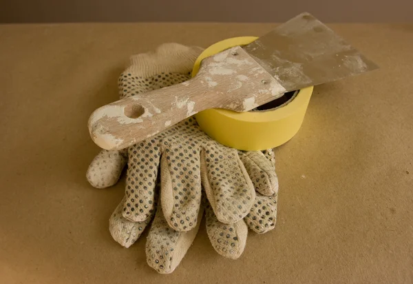 Gloves and putty knife — Stock Photo, Image