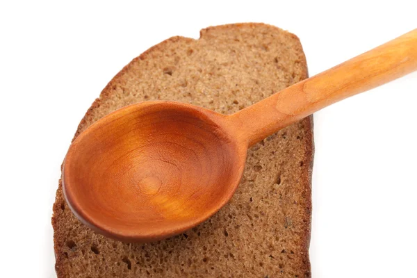 Cucchiaio di legno e una fetta di pane — Foto Stock