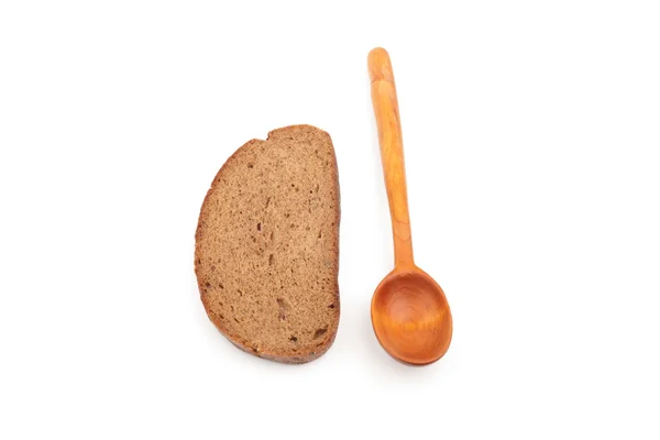 Colher de madeira e uma fatia de pão — Fotografia de Stock