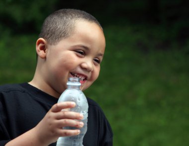 Latino boy with bottle clipart