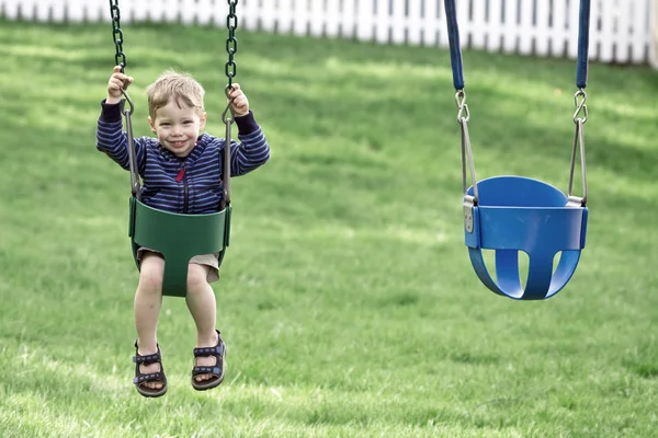 Boy in swing — Zdjęcie stockowe