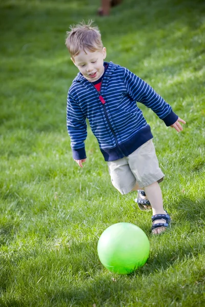 Chłopiec kopie piłkę — Zdjęcie stockowe