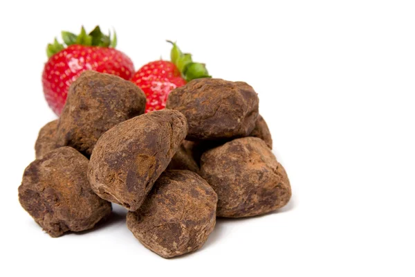 Strawberries and chocolate truffles — Stock Photo, Image