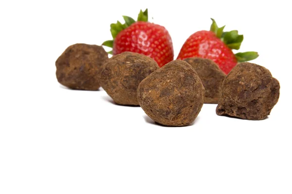 Strawberries and chocolate truffles — Stock Photo, Image