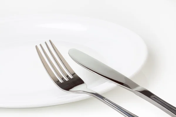 Kitchen plate and knife and fork — Stock Photo, Image