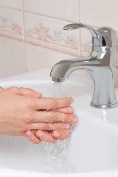 stock image Woman washing hands in bathroom