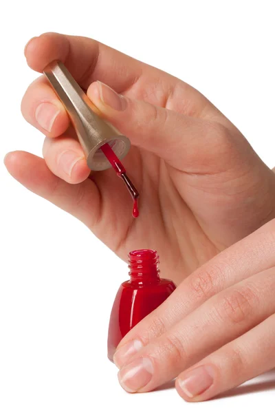 Mujer aplicando esmalte de uñas rojo —  Fotos de Stock