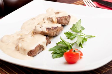 Roasted meat under white sauce clipart