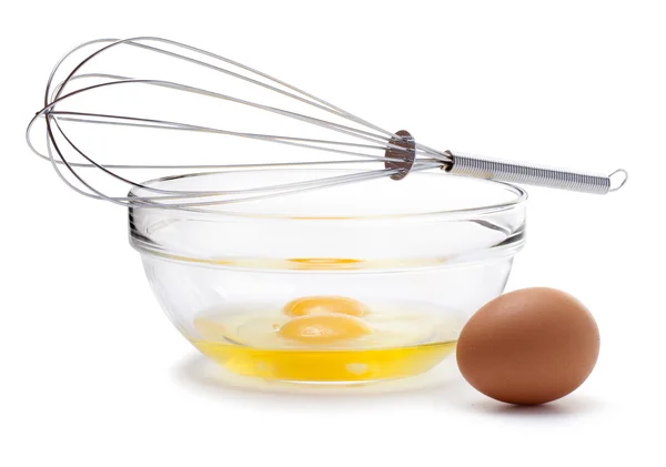 Wire whisk and brown eggs, isolated on white. — Stock Photo, Image