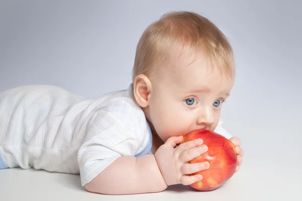 Small baby with apples — Stock Photo, Image