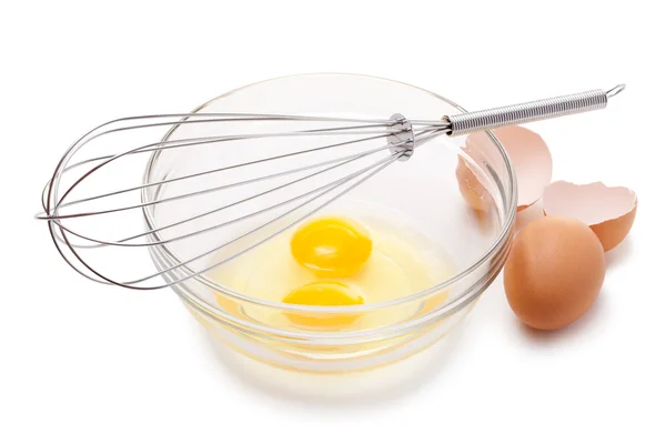 stock image Wire whisk and brown eggs, isolated on white.