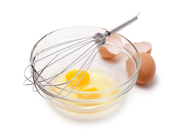 Wire whisk and brown eggs, isolated on white. — Stock Photo, Image