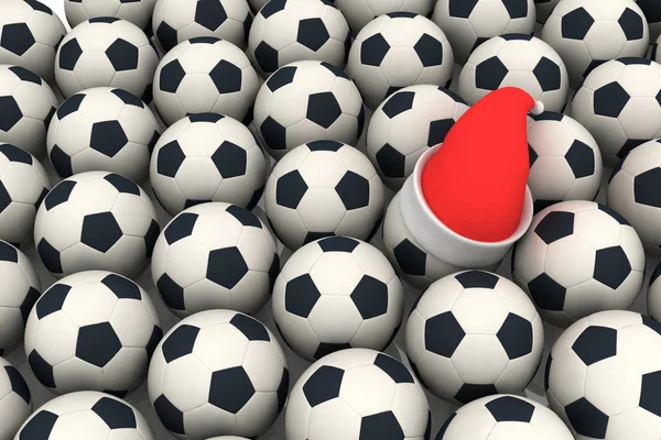 Soccer balls and santa claus red hat — Stock Photo, Image