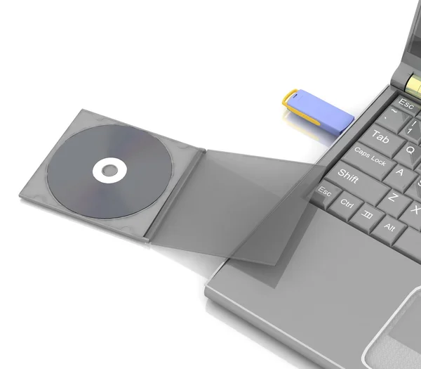 CD se encuentra junto a un portátil en el que la unidad flash insertada —  Fotos de Stock