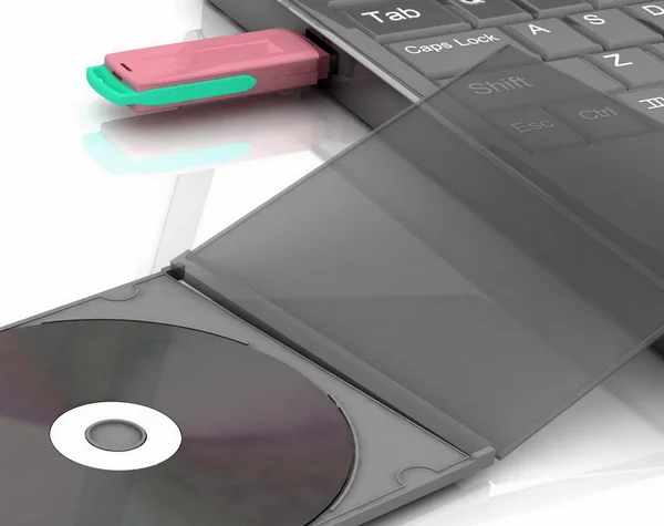 CD se encuentra junto a un portátil en el que se inserta la unidad flash. aislado en blanco —  Fotos de Stock