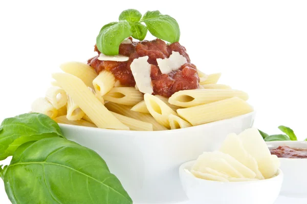 Penne in bowl decorated with fresh basil — Stock Photo, Image