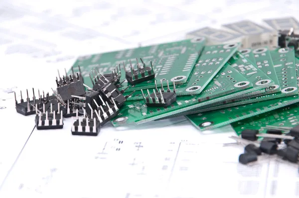 Circuit boards and components with schematics in background — Stock Photo, Image