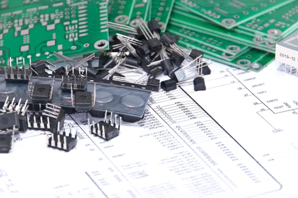 Circuit boards and components with schematics in background — Stock Photo, Image