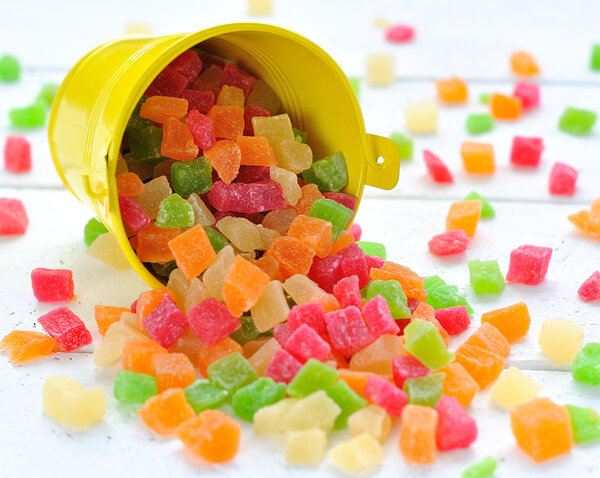 Colorful candied fruits in a small bucket