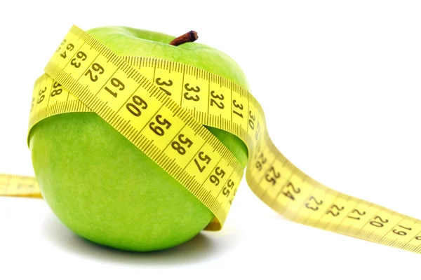 Green apple and measuring tape — Stock Photo, Image