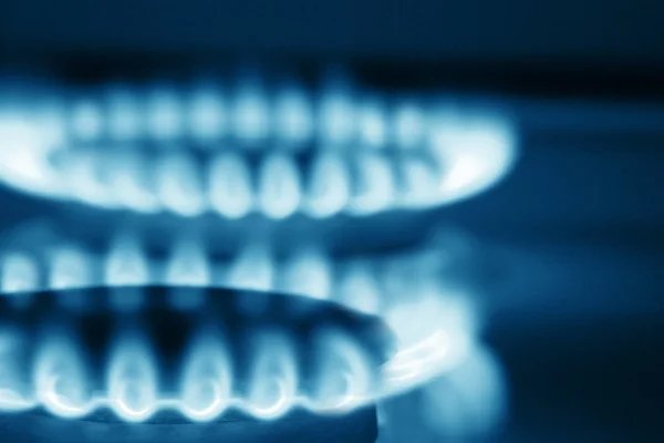 stock image Close up view on two burners of cooker (blue toned)