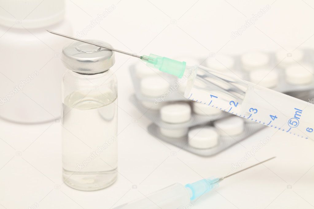 Medical still-life with syringes and tablets