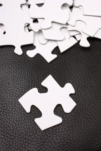 Jigsaw Pieces on Leather Background — Stock Photo, Image