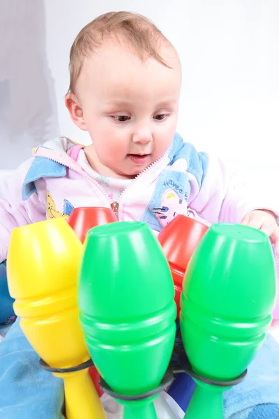 Child plays with bright toys — Stock Photo, Image