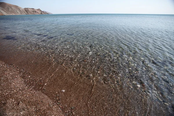 stock image Through the clear sea water can be seen rock bottom