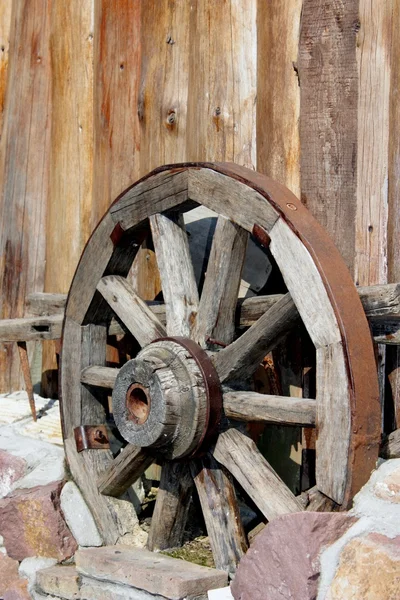 stock image Wooden wheel on the fence