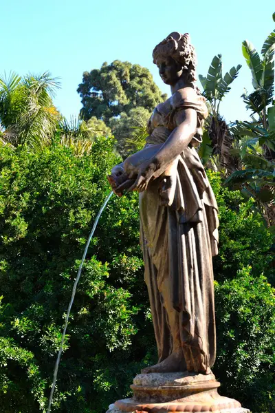 Women with water statue in park malaga