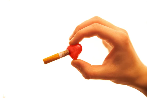 Cigarette burns heart Royalty Free Stock Images