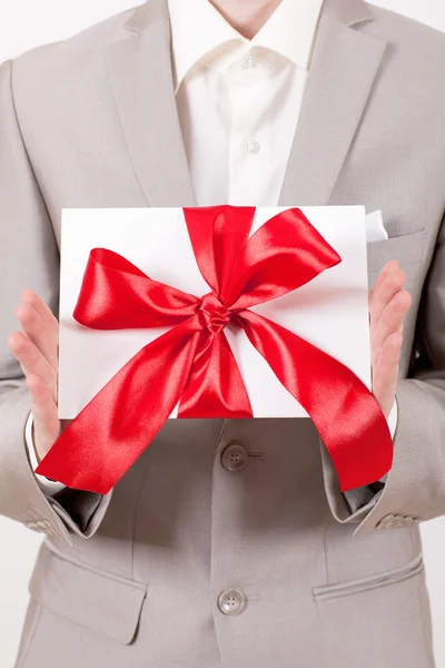 Gift with decorative red ribbon bow — Stock Photo, Image
