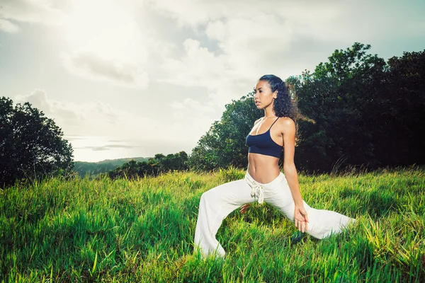 Красива жінка практикує йогу зовні в природі — стокове фото